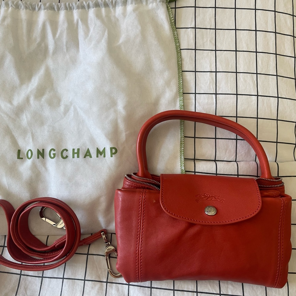 Longchamp le pliage cuir in a deep orange tone color.  Size small/med